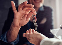 Image of Person Handing Over Keys to a House